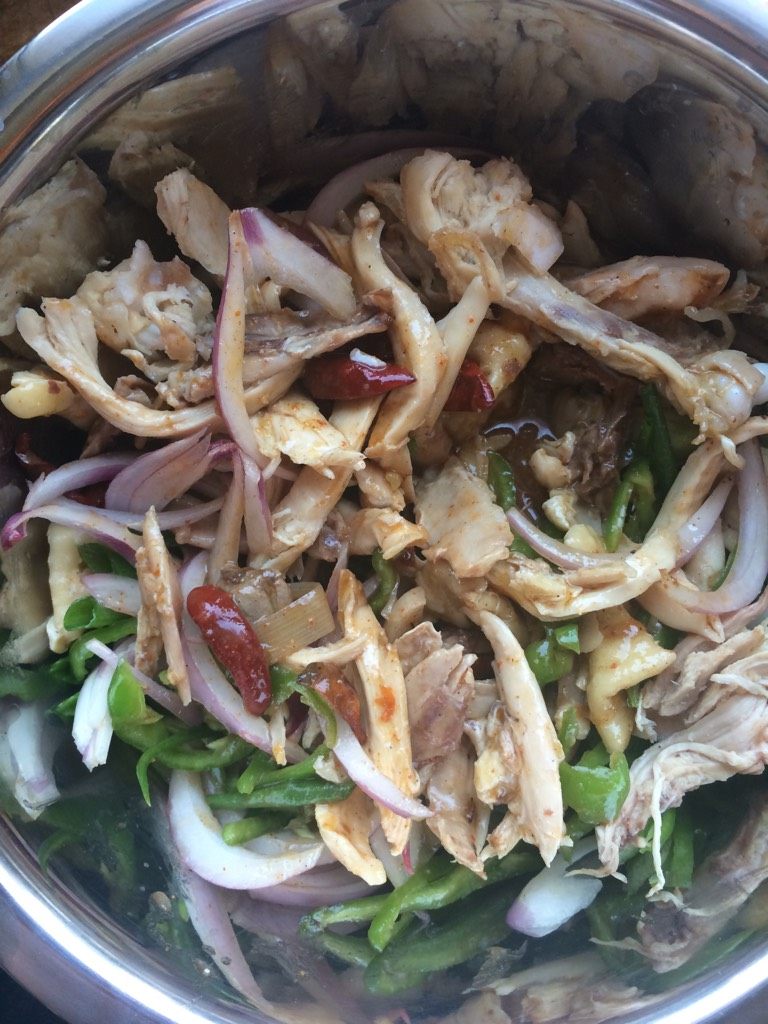 新疆美食【椒麻鸡】,如图将切好的配菜跟鸡肉混合一起,倒入熬好的料汤
