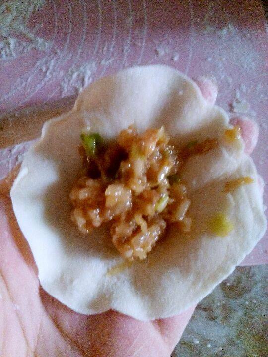 牛肉萝卜馅蒸饺,用热水和烫面面团,醒半个小时左右。擀成面皮后,放入适量的馅。