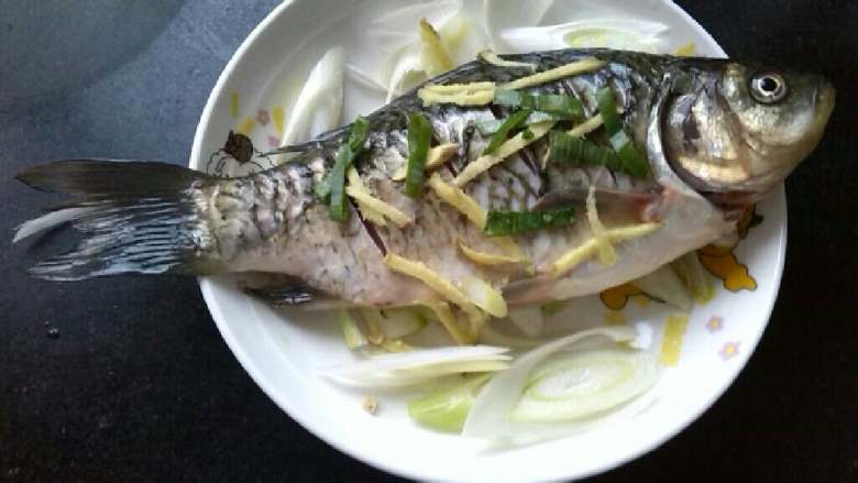 ≈蒸鱼≈,把鱼杀好，洗净，在鱼身上划几刀方便入味，两面都抹上盐，切几片大葱铺在盘底，在切姜丝撒在鱼身上