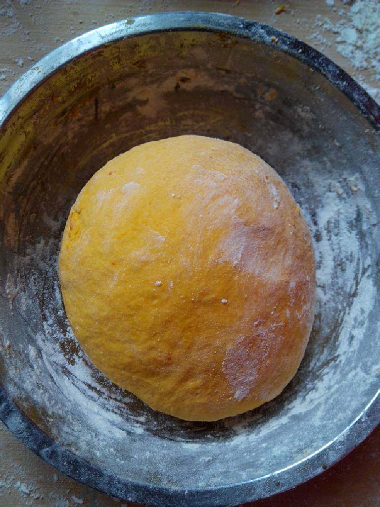 南瓜玫瑰花卷,揉好的面团盖上湿纱布放在温暖的地方,发酵2小时,体积成为原来的2倍大。