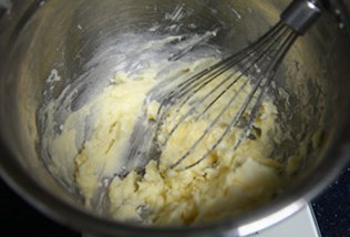 小松鼠饼干,黄油从冰箱取出室温软化。两份黄油软化后各自加入糖粉,搅打均匀。