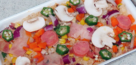 飘香培根芝士焗饭,把饭铺入烤盘，表面再铺上预留下的各种主料