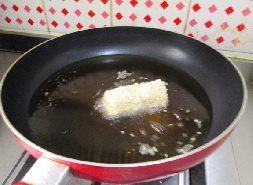 芝麻烤肠吐司卷,锅中注入油,烧热将吐司卷封口朝下放入油锅中。