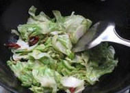 手撕包菜小炒肉,锅中留底油，将辣椒和大蒜，<a style='color:red;display:inline-block;' href='/shicai/ 700'>花椒</a>放入，小火炸出香味后放入包菜