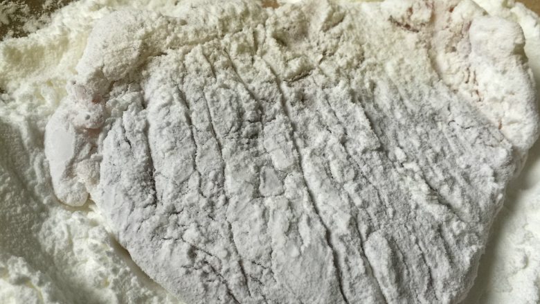 日式猪排,将大排肉均匀裹上淀粉,包括侧边,抖去多余散粉。