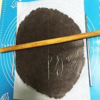 奥利奥夹心饼干,放在软硅胶垫上,包油纸用擀面杖擀成约0.5厘米薄片。开始不好擀的时候可以在两边垫一双筷子,擀到筷子高度时再继续擀薄就容易多了。