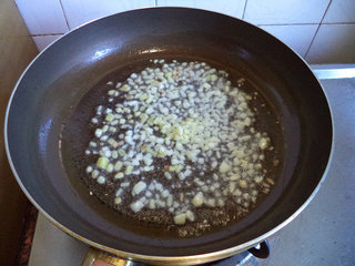 九层塔炒薄壳,锅烧热后,放油,爆香姜蒜。