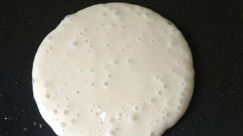香蕉糯米饼,平底不粘锅刷油,小火加热,距锅15CM左右,垂直淋入一大勺面糊,面糊自然滴落在锅中,会形成一个圆