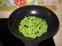 芽菜扁豆炒鸡片,重起锅倒油，爆香葱姜后倒入扁豆，一直炒至扁豆表皮起皱，几乎全熟（这步用时比较长，其间可淋入少许水，并盖上盖子焖一下）；