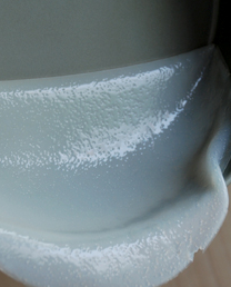 自制凉皮/面筋,蒸好的模子取出马上放进一个冷水盆中冷却（我发现这是在毁不粘模，还是别用不粘模了，用披萨盘做前抹一点油就可以），冷却后撕下凉皮，每张上都抹点油防粘。