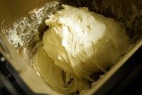 懒人版奶香提子吐司面包,一个和面程序后,面团应如图般比较湿、粘,如果面团已经很光滑,那烤出来必定很干,这时可在这个环节再倒点牛奶进去