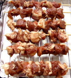 新疆羊肉串,此时烤箱先预热。干净的竹签泡水洗净，将一块羊肉，一块脂肪的方法全部串好放入烤架上，下面的烤盘垫上锡纸，以免油污染。