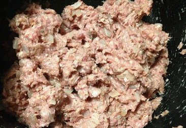 芝士牛肉堡,炒洋葱的平底不粘锅(原锅不用清洗)倒少许油,将手沾湿后弄约五分之一的肉馅,团圆后按扁,做成肉饼状,直径约比面包胚略大一点点(煎熟后会回缩变小);