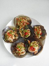 蒜蓉蒸带子,蒸好后端出锅,去掉保鲜膜,每个带子淋1/2汤匙的<a style='color:red;display:inline-block;' href='/shicai/ 864'>蒸鱼豉油</a>,撒上些泰椒末,葱末和香菜末。
