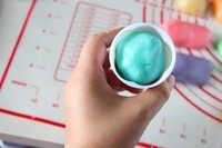 立体月饼,手上沾少许熟粉,将包好馅的月饼球在手心里搓一下让月饼球表面粘上一层薄薄的熟粉,再将月饼球放进月饼模具里。