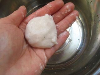 包心鱼丸,锅中倒入清水备用。手上蘸一些清水,取适量鱼胶。