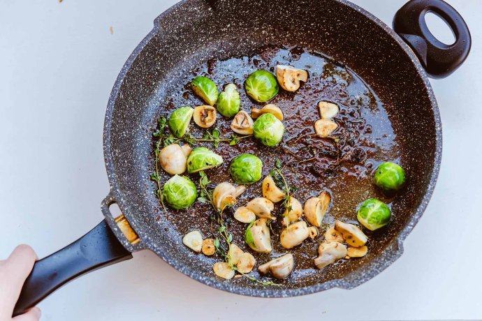 培根扇贝卷,用锅中的余油煎蔬菜，放入口蘑与抱子甘蓝，香草