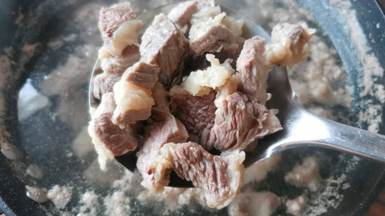 红焖牛肉煲,焯好后撇去浮末,准备捞出。