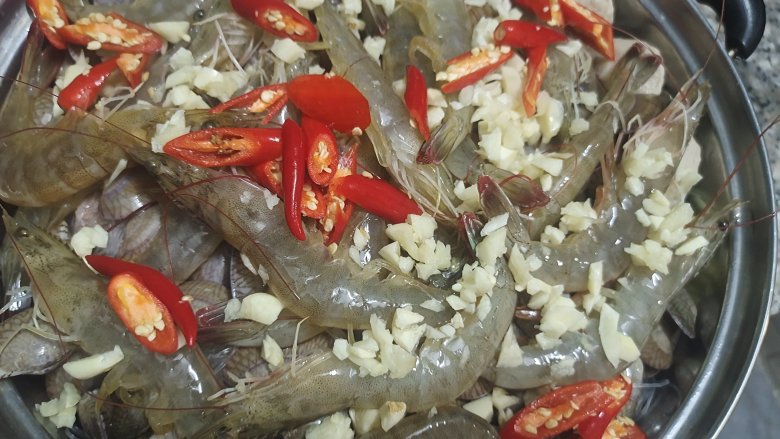 花甲粉丝煲(火锅),放入一半的蒜末跟小米辣(另外一半留着调酱汁)