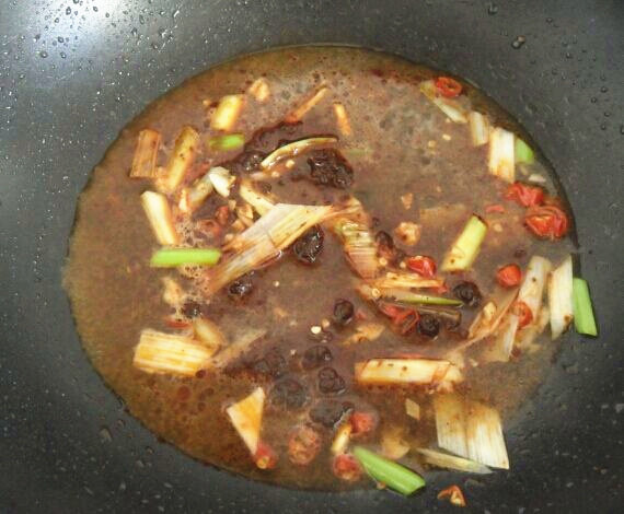 地方菜　四川麻婆豆腐,另起锅放底油，油热放葱蒜辣椒和花椒炒出香味。放豆瓣酱、加水。