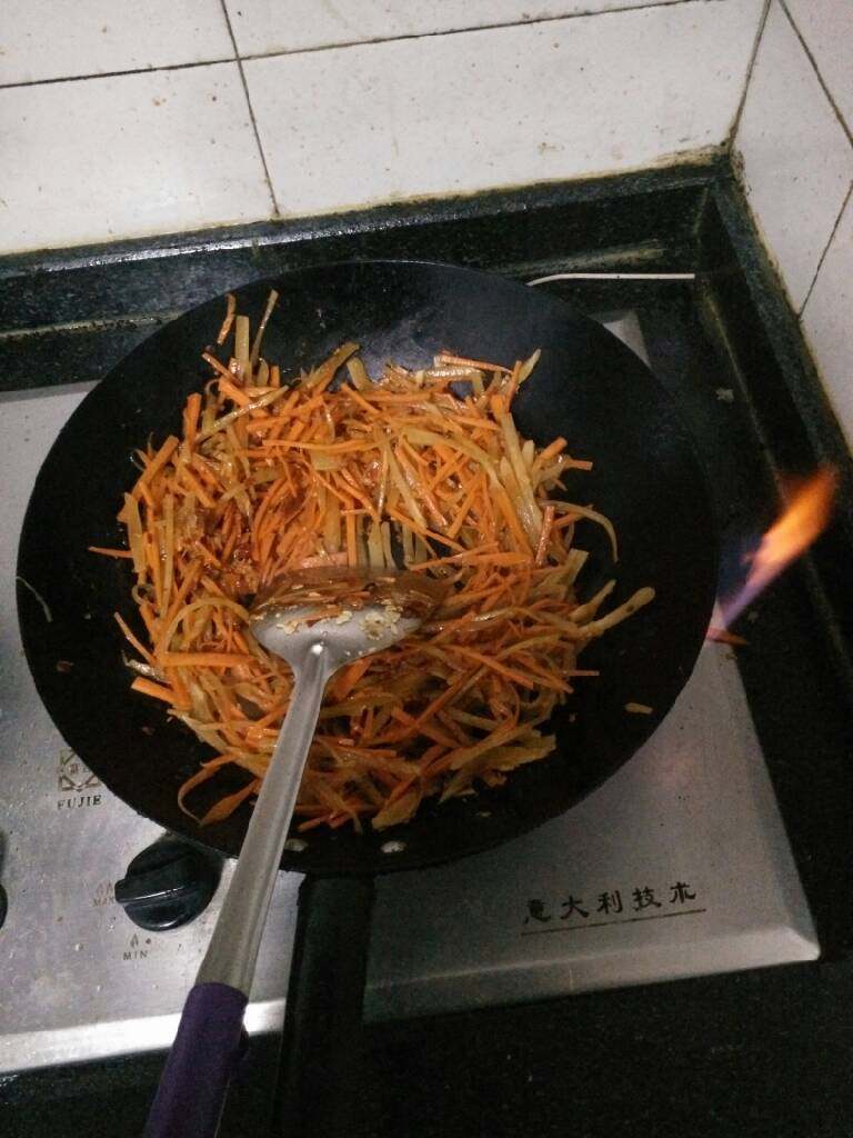 家做北方鱼香肉丝,把胡萝卜,莴笋头的切丝倒入锅中翻炒至半熟