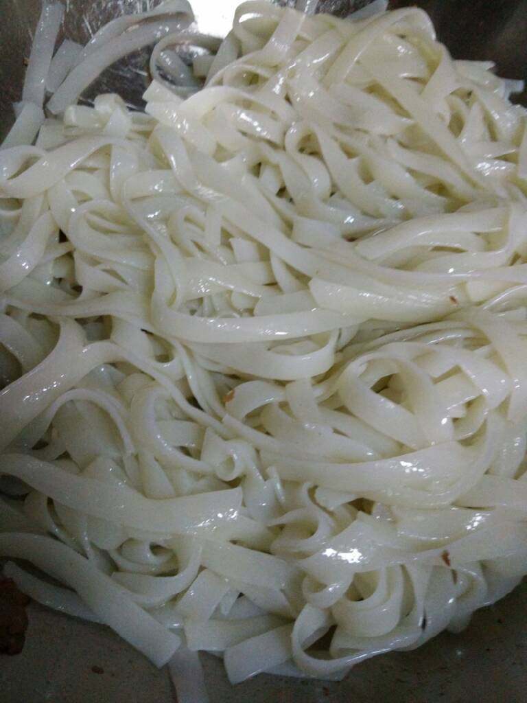 地方菜 干炒牛河,热锅放油,放河粉煎一下,然后放入洋葱和葱段翻炒