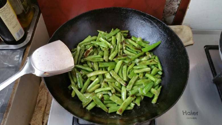 豆角焖面,将煸炒后的豆角平铺在肉上。