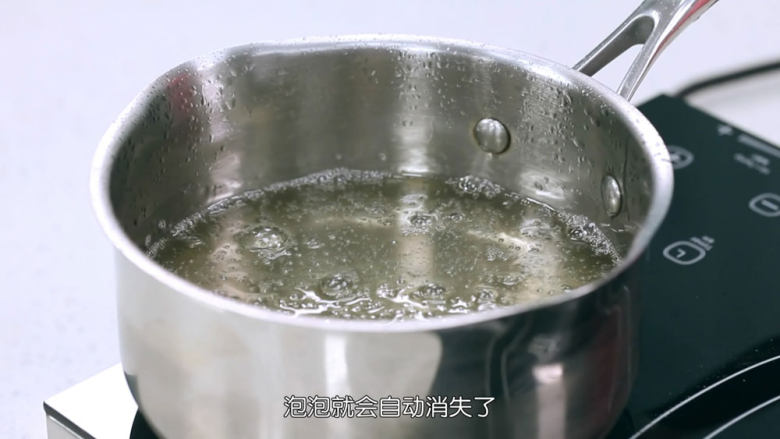 冰晶棒棒糖,待糖水煮到110度之后,你会看见表面很多泡泡,这个时候,不要搅拌也不要去动它,把锅子拿开火,放在一旁,过一会它的泡泡就会消失了