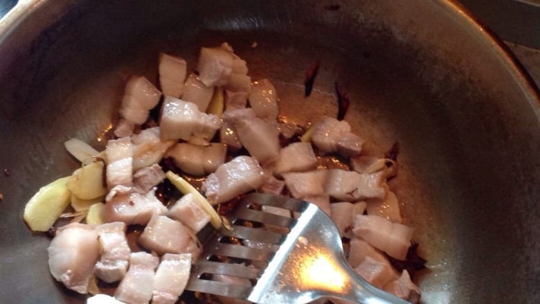 红烧肉炖土豆,重新开火,倒油,葱,姜,炒香,倒入肉,翻炒,