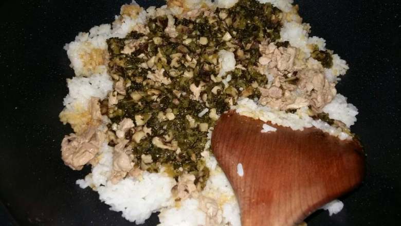 咸菜炒饭,加入米饭和先炒熟的瘦肉,适量调入酱油和鱼露(潮汕特色调味料),翻炒均匀,最后可以撒上芹菜粒
