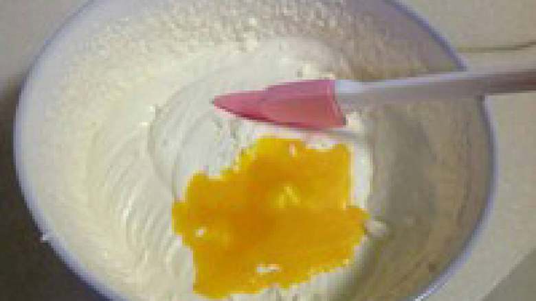 自制哈根达斯风味冰激凌,将蛋黄液分次加入到打发的淡奶油中,加一次,用刮刀拌匀一次,直到全部混合均匀。