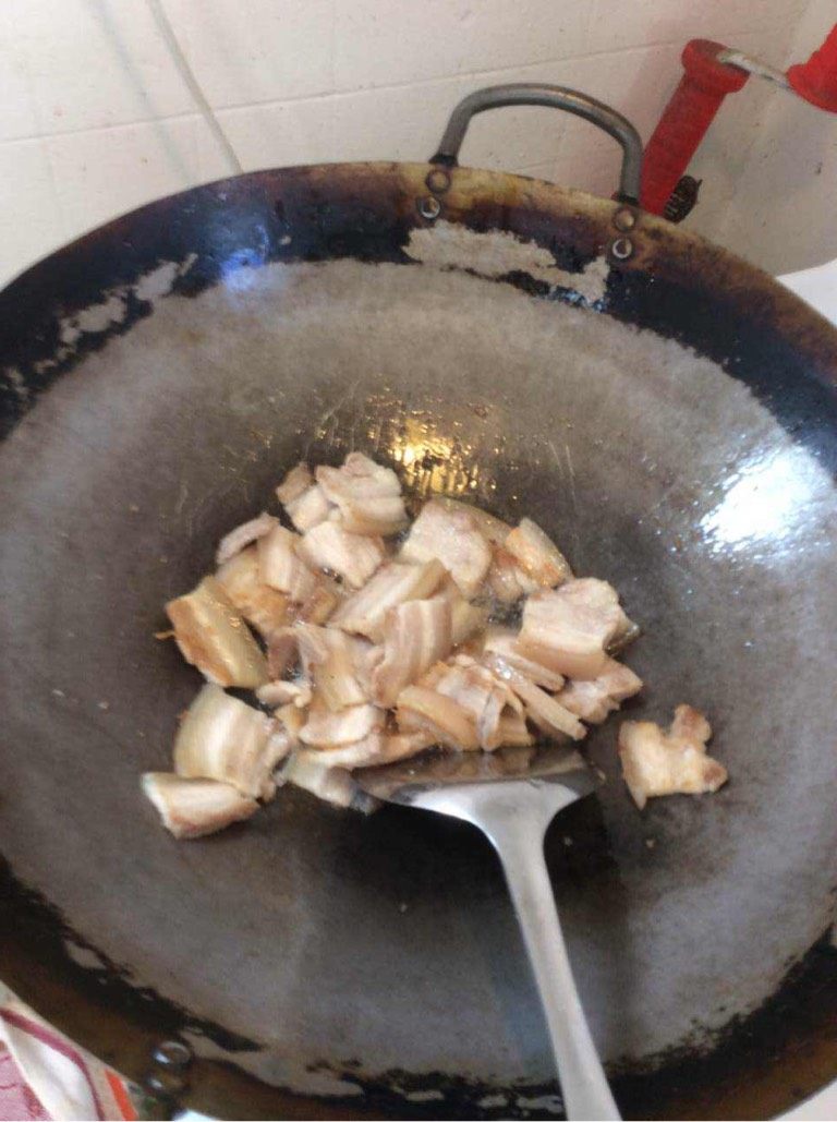 回锅肉,开火热油锅,放入姜丝翻炒几下后放入五花腩,煎出猪油