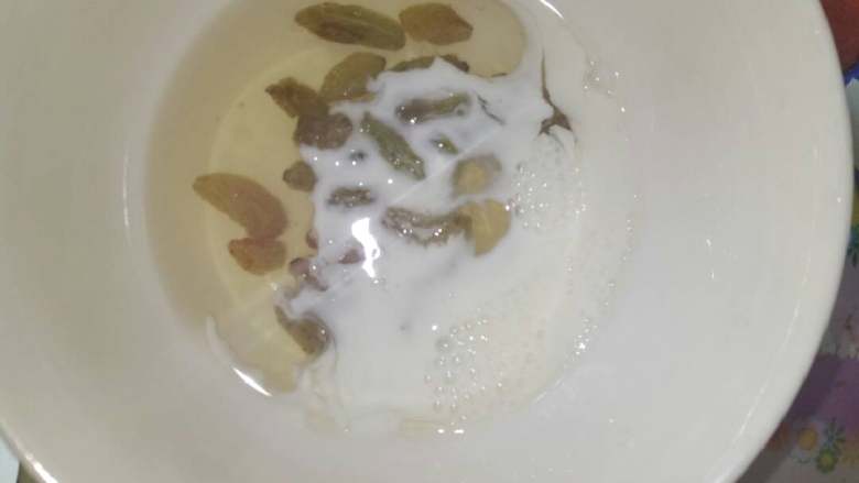 鸳鸯戏水❤❤#甜蜜美味#,剩下的蛋清加入白糖,牛奶,葡萄干,入锅煎成饼状。