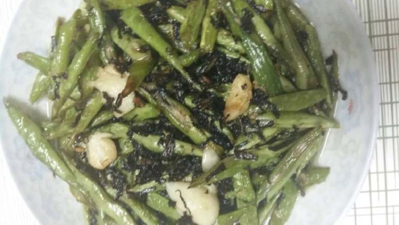 四季豆梅干菜,炒到四季豆有点皱巴巴了加入梅干菜鸡精,翻炒片刻起锅装盘。