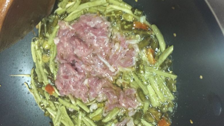 泡菜肉丝,加入蒜粒爆香后加入码好的肉丝,迅速翻炒