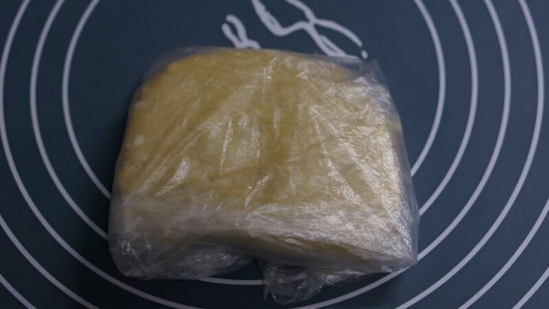 香脆的杏仁小酥饼,用保鲜膜把面团包起来压平,放入冰箱冷藏1个小时。