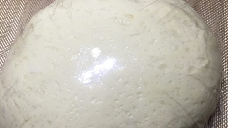 蔓越莓奶酪软面包,由于水量比较大,面团粘性较大,用面包机揉至接近扩展阶段时,被我直接抓出来,在案板上手工揉并摔打出筋,直到扩展。随后盖上保鲜膜第一次发酵。