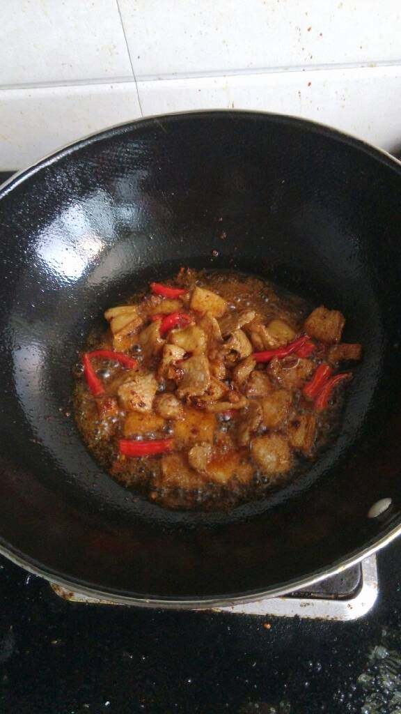 秋葵小炒肉,放入生姜，蒜末，猪瘦肉和红辣椒，放黄酒，老抽调味，加入一勺老干妈酱