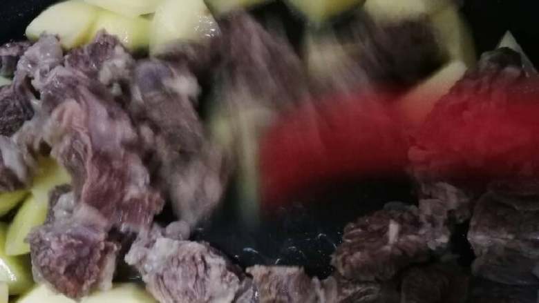 土豆烧牛腩,翻炒片刻后加牛腩块一起翻炒。