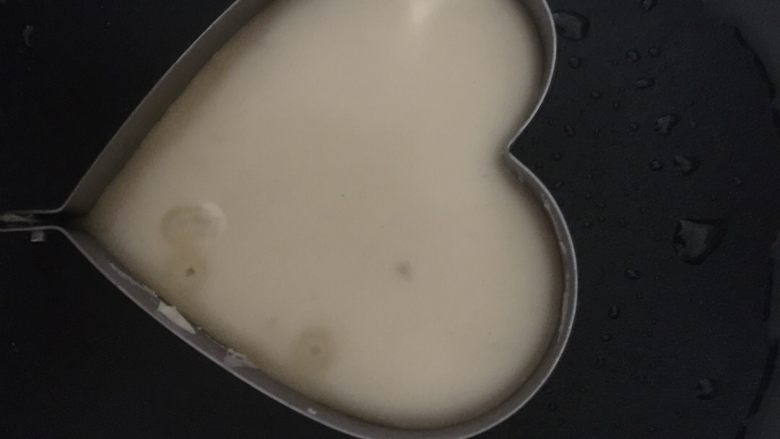 四叶草牛奶鸡蛋饼,然后给锅里面倒入色拉油,油烧热以后,把调好的面糊倒进一个心形模具里面。