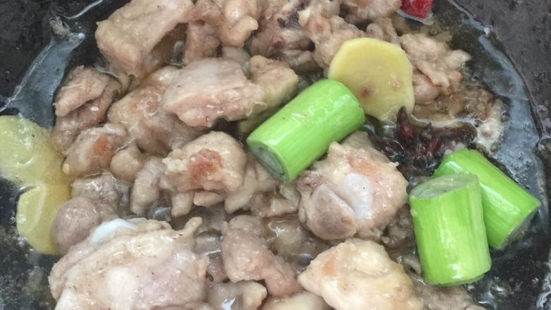 黄焖栗子鸡,适量油翻炒鸡腿~鸡腿变色后再加入挑出去的香料(葱姜大料什么的,我这次油加多了~大家一定要注意放油的量)