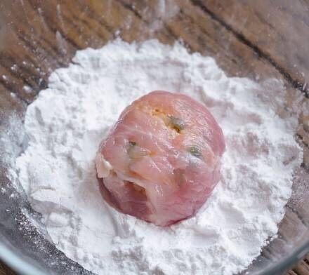 肉肉饭团,倒适量玉米淀粉在碗里，将包好的饭团裹上一层淀粉备用