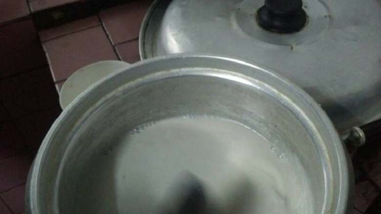 自制黑豆豆腐,煮好后放至有点烫手就可以开始撒盐水,因为卤水比较难搞,盐水简单。用手慢慢撒,一边撒一边用勺子轻轻在表面转圈。