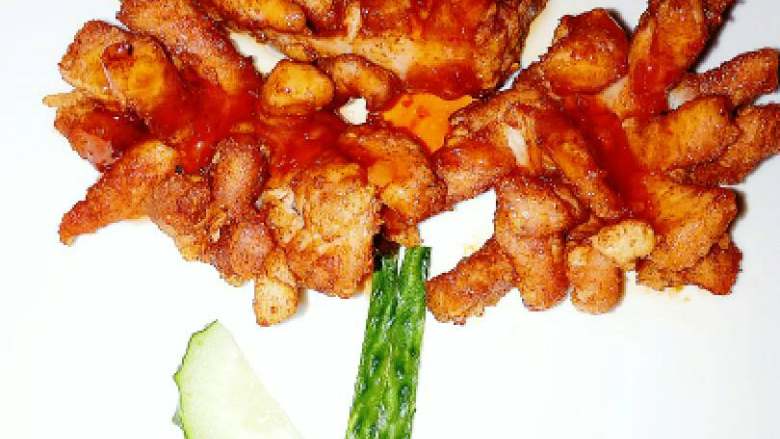 泰式菊花酥肉,沥干油摆盘，在菊花酥肉上，淋适量泰式甜辣酱即可