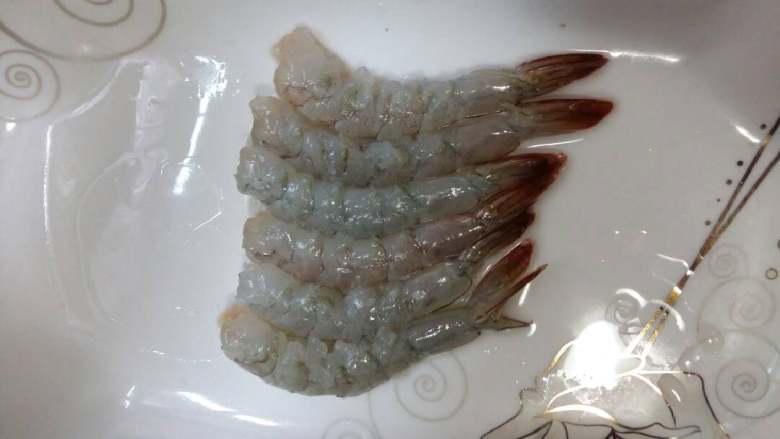 虾骨柔情天妇罗,摘去虾头,轻轻地剥掉外壳,抽出虾线。