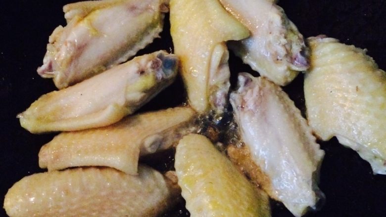 可乐鸡翅,锅里放适量的油，高温时把鸡翅放入，煎