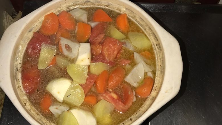 砂锅牛肉乱炖,将西红柿,煸炒后的土豆,莲藕,胡萝卜下入砂锅,