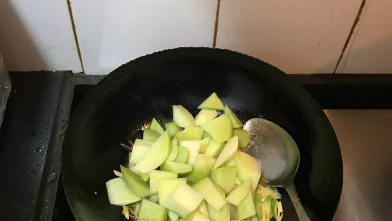 青萝卜烧牛腩,爆香后倒入青萝卜块翻炒