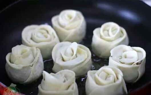 玫瑰花煎饺,平底锅里加入适量油,放入玫瑰花饺子中火煎