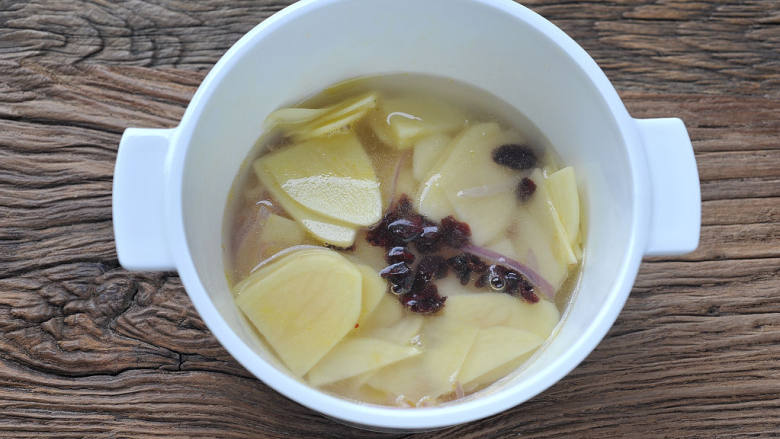 蔓越莓土豆浓汤,放入蔓越莓,加清水至食材齐平,煮开后加盖转小火焖煮5分钟。